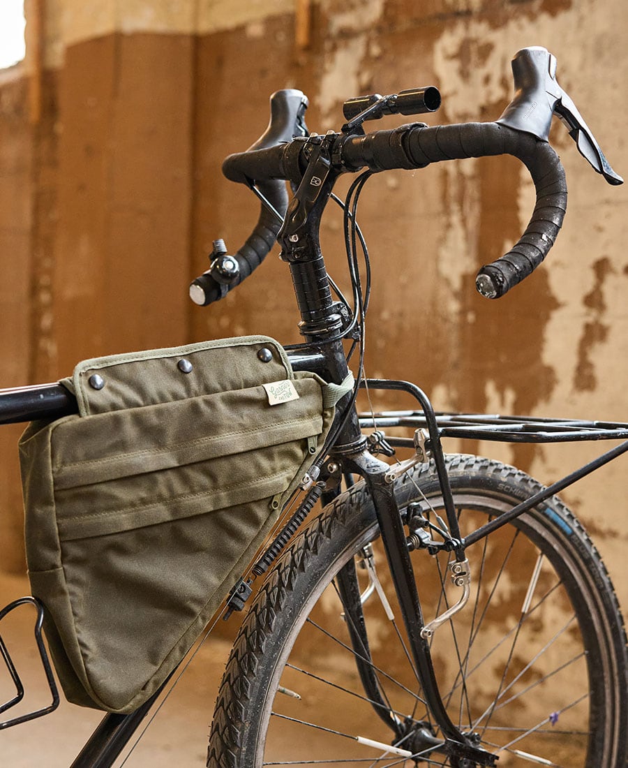 a green frame bag on a bike