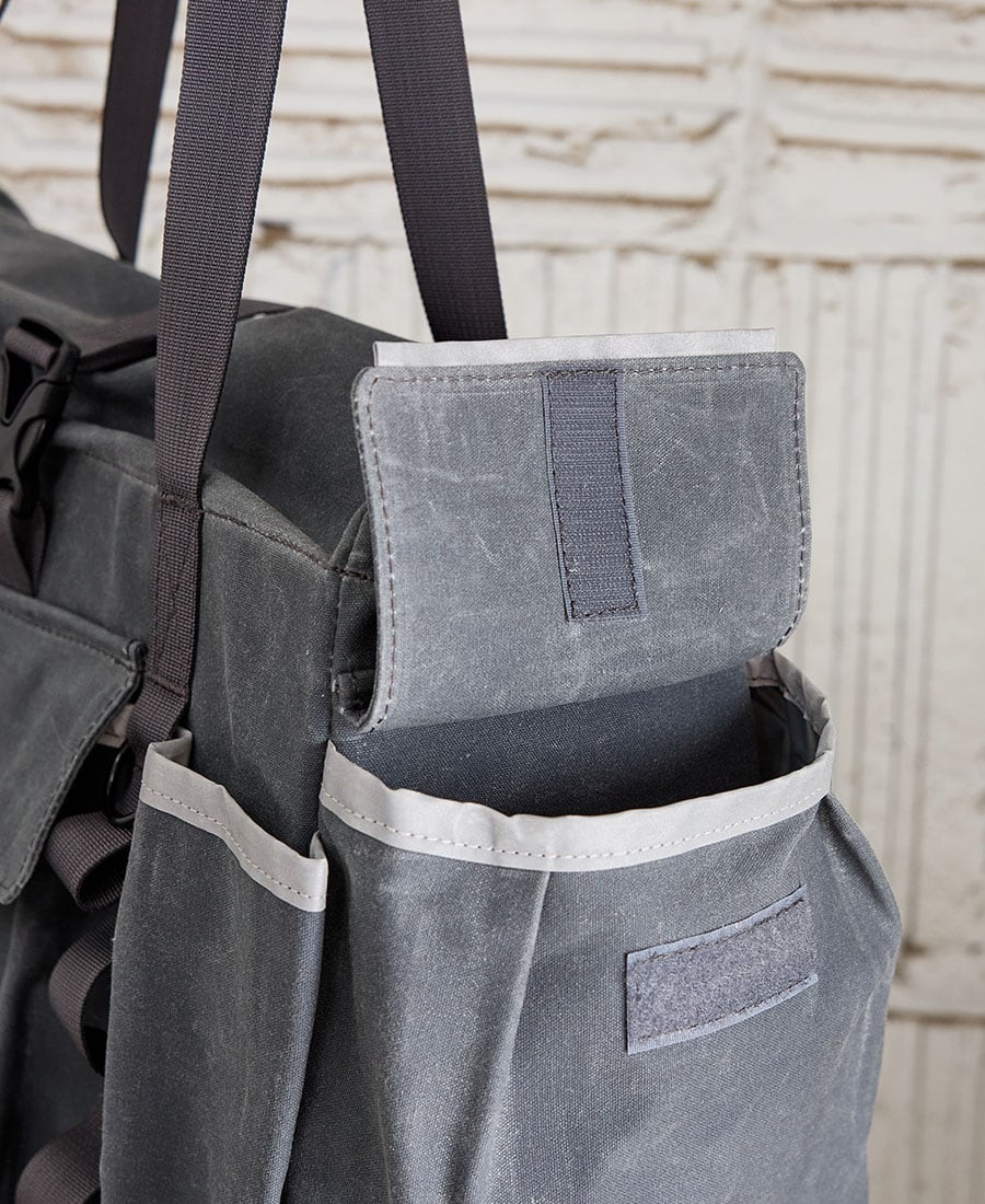 an open water bottle pocket on the garner and tow tote bag